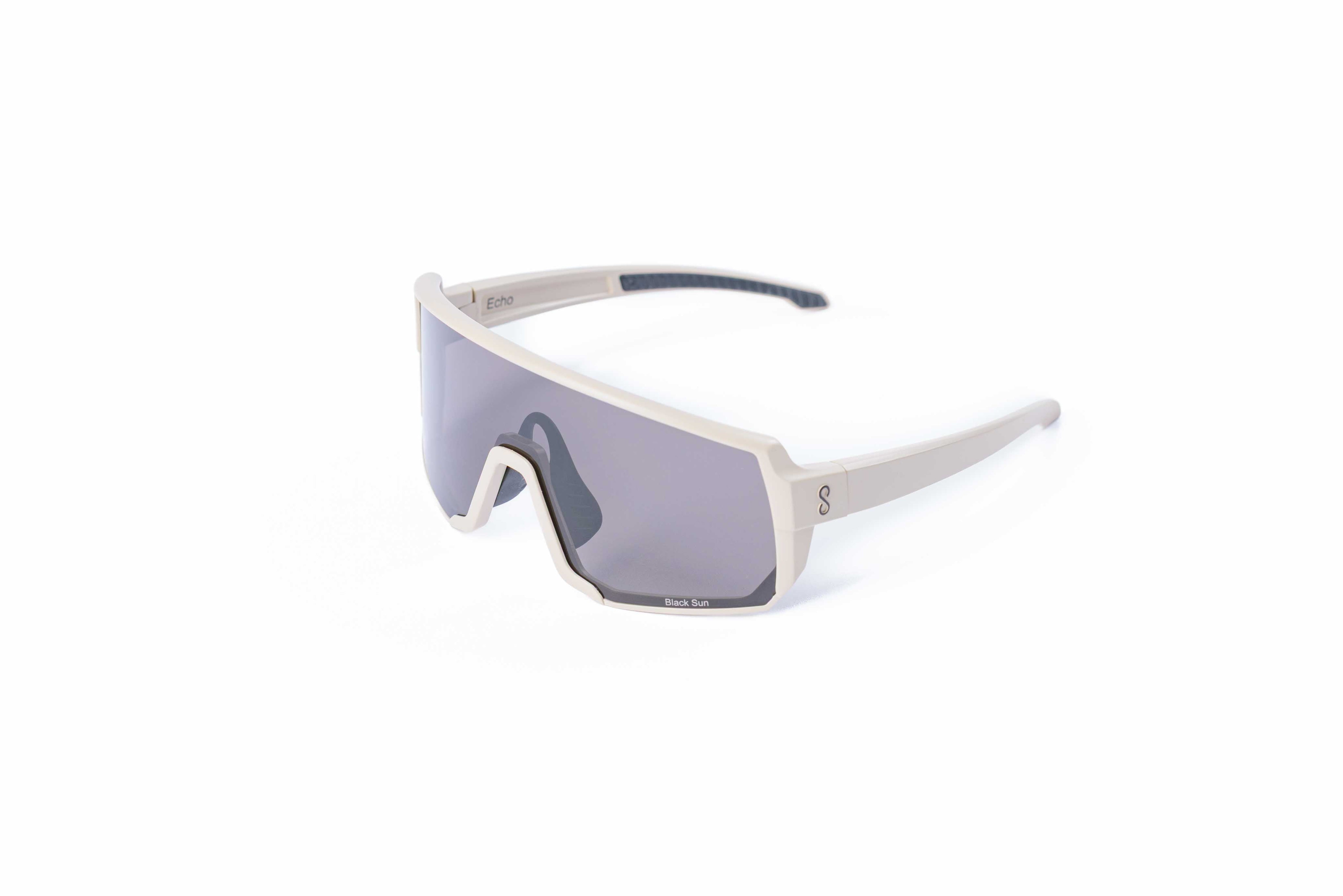 Small size cream sunglasses with an interchangeable black lens on a white background