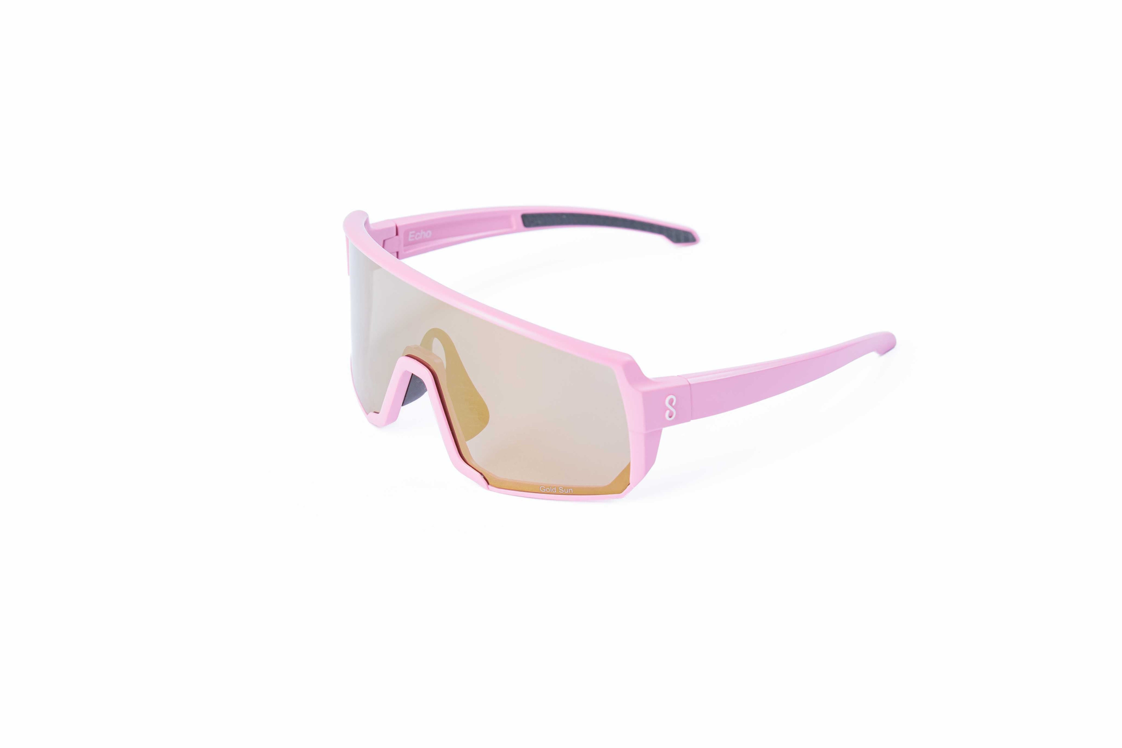 Pink sunglasses with an interchangeable gold lens on a white background