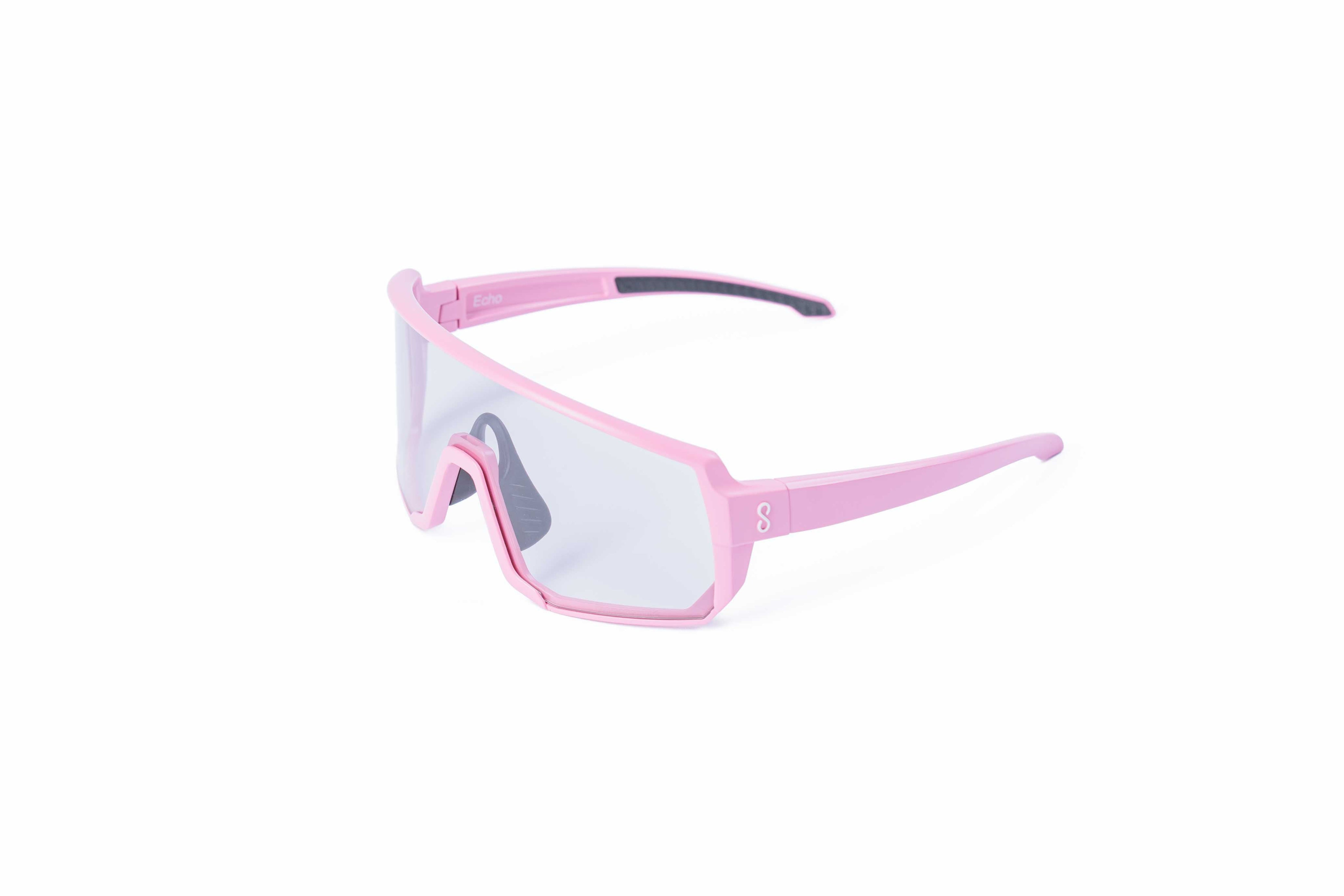 Pink sunglasses with an interchangeable photochromatic lens on a white background