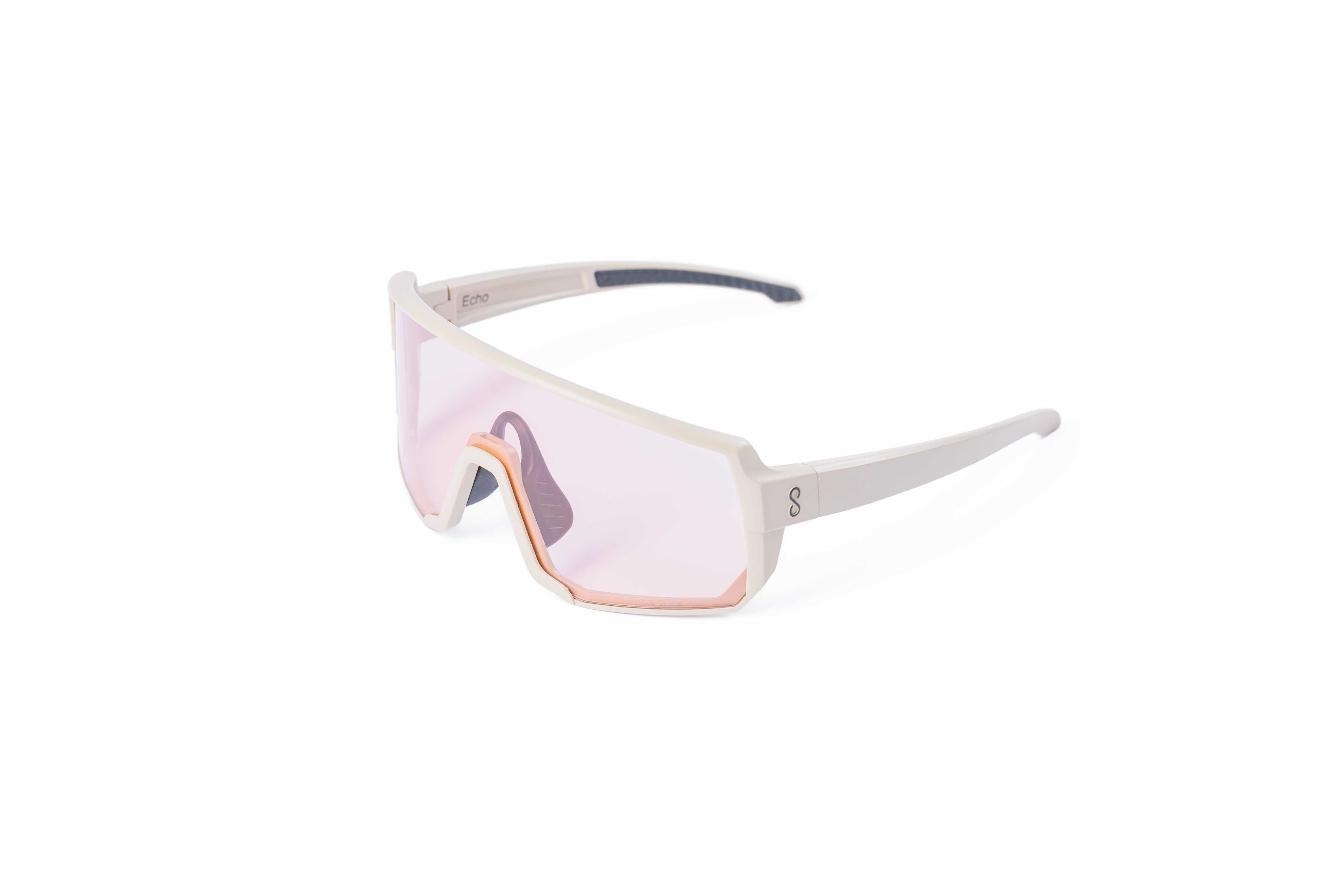 Small size cream sunglasses with an interchangeable pink lens on a white background
