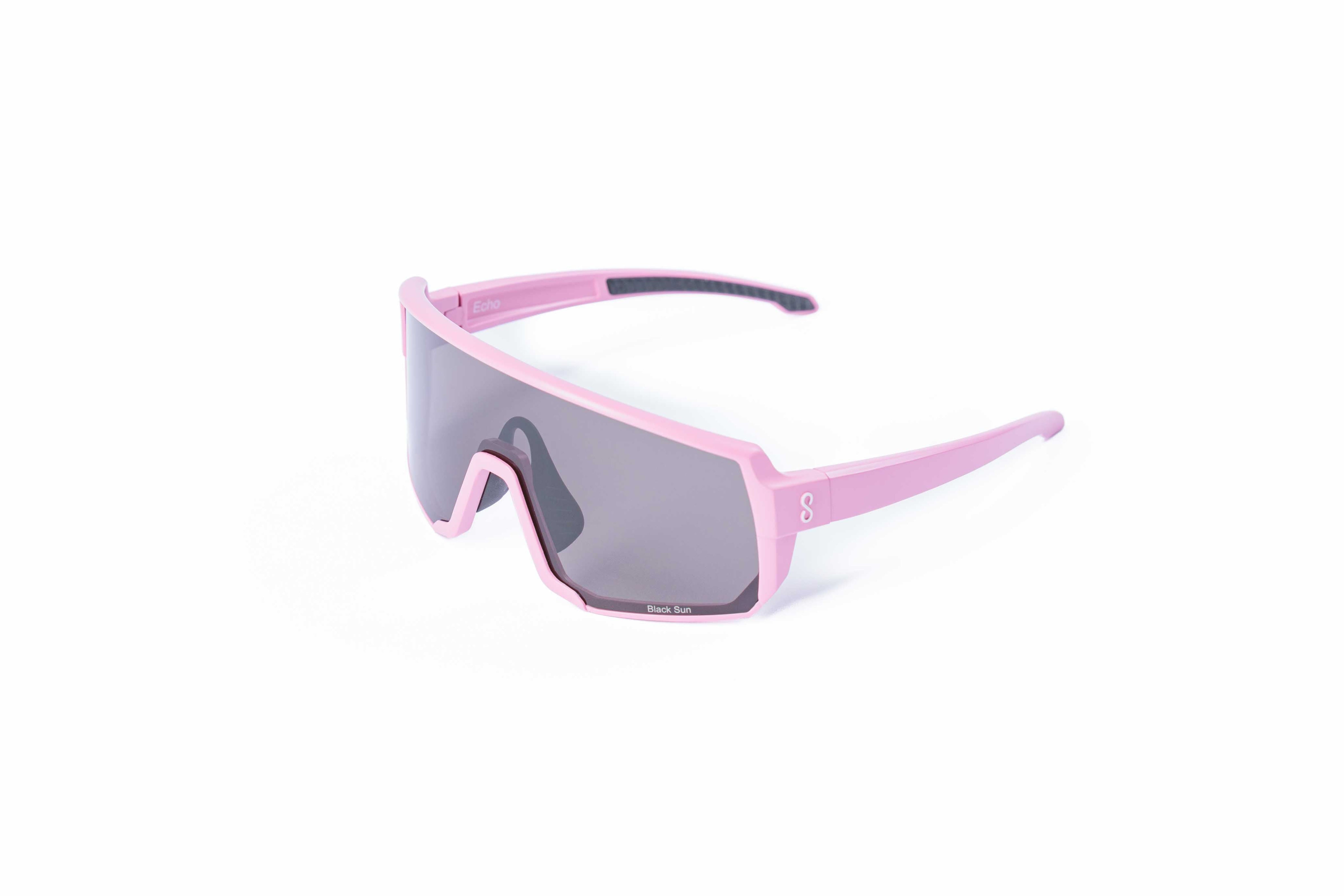 Pink sunglasses with an interchangeable black lens on a white background