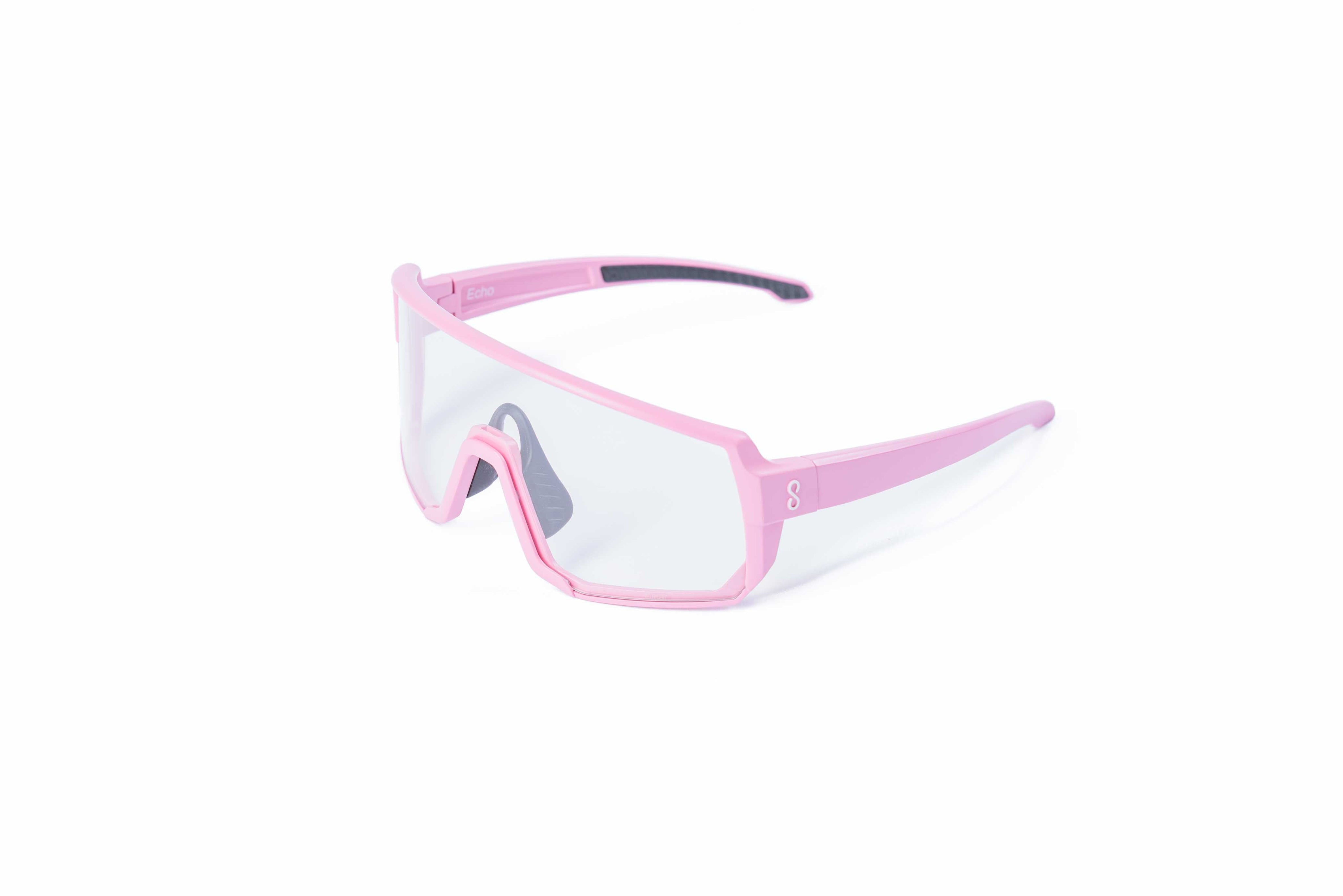 Pink sunglasses with an interchangeable clear lens on a white background